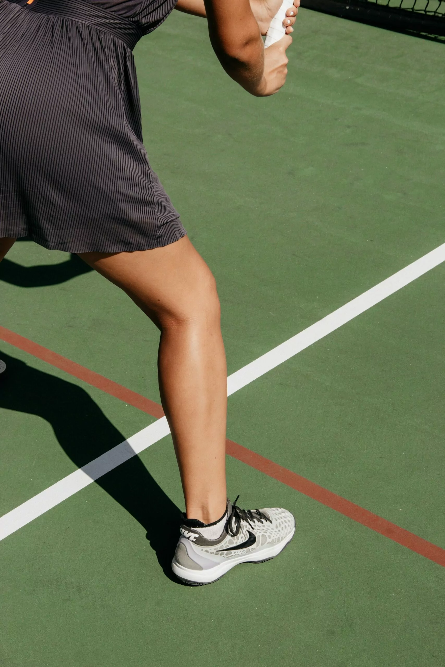 Lady Playing Tennis Leg Shot